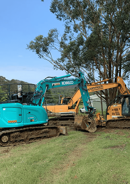 A Blue Kobelco and Yellow Jammach Excavator — Jammach Earthmoving in Maitland, NSW
